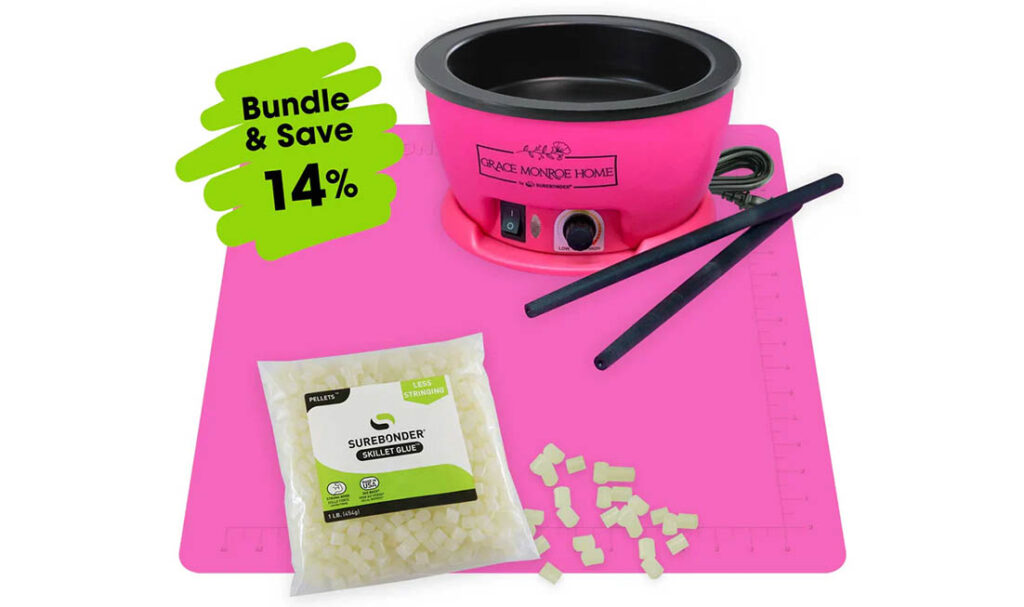 Pink wax warmer kit with wax beads and sticks for hair removal.